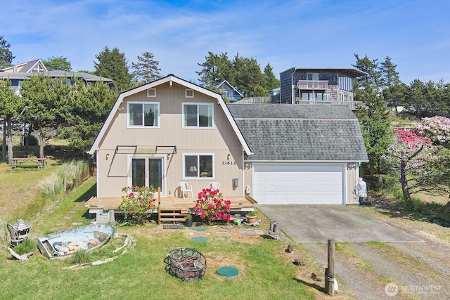 33612 I St, Ocean Park, WA 98640 - view of front facade with a gambrel roof, a shingled roof, a wooden deck, a front lawn, and an outdoor fire pit