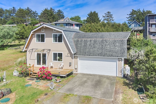 33612 I St, Ocean Park, WA 98640 - view of front facade with roof with shingles, a gambrel roof, a deck, driveway, and a front yard