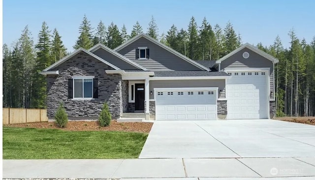 13513 100th St NE Unit 215, Lake Stevens, WA 98258 - view of front of house with an attached garage, stone siding, and concrete driveway