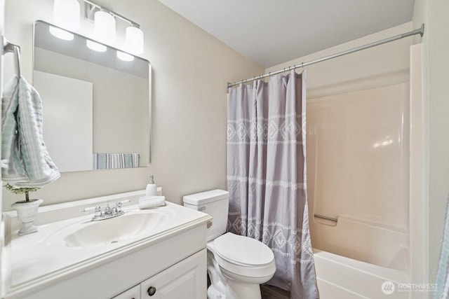 full bath featuring toilet, vanity, and shower / tub combo
