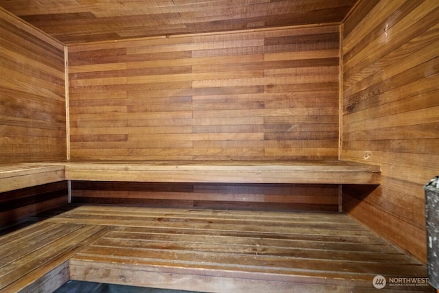 sauna with wooden ceiling and wooden walls