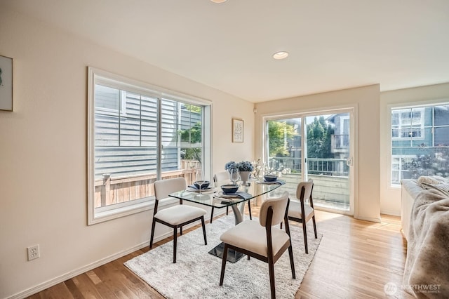 dining space featuring light wood-type flooring, baseboards, and recessed lighting