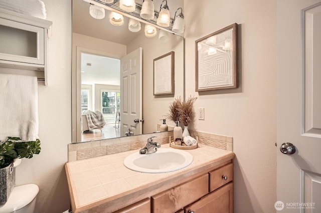 half bathroom featuring toilet and vanity