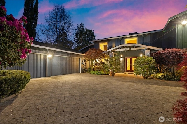 view of front facade featuring a garage and decorative driveway