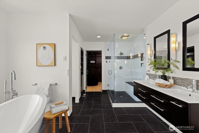 full bath with a shower stall, a freestanding bath, vanity, and tile patterned floors