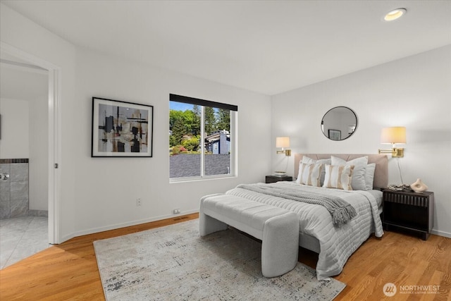 bedroom with light wood-style floors and baseboards