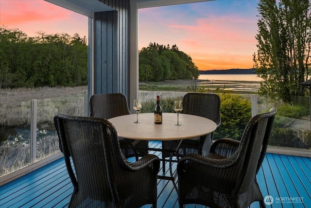 balcony at dusk with outdoor dining space