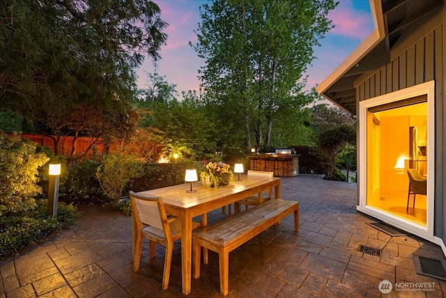 view of patio with outdoor dining space and fence