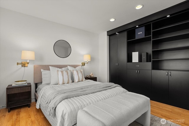 bedroom with light wood-style flooring and recessed lighting