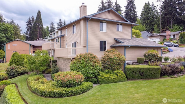view of home's exterior featuring a chimney and a lawn