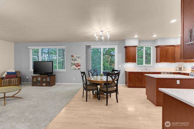 dining area with baseboards, light wood-type flooring, a chandelier, and recessed lighting