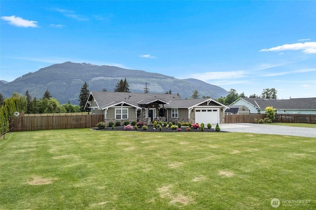 ranch-style house featuring driveway, a mountain view, a garage, and stone siding