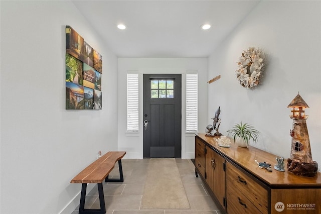 foyer with recessed lighting, baseboards, and light tile patterned flooring