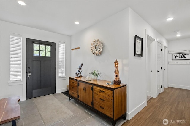foyer featuring recessed lighting and baseboards