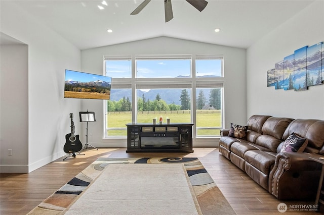 living room with wood finished floors, vaulted ceiling, a ceiling fan, baseboards, and recessed lighting