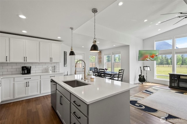 kitchen featuring a sink, recessed lighting, dark wood finished floors, light countertops, and pendant lighting