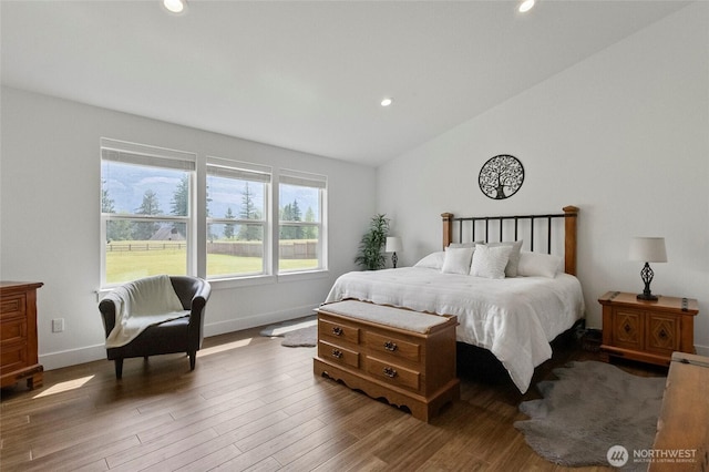 bedroom featuring recessed lighting, wood finished floors, baseboards, and lofted ceiling