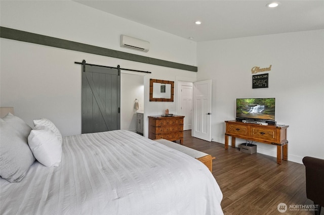 bedroom featuring a wall unit AC, a barn door, recessed lighting, dark wood-style flooring, and baseboards