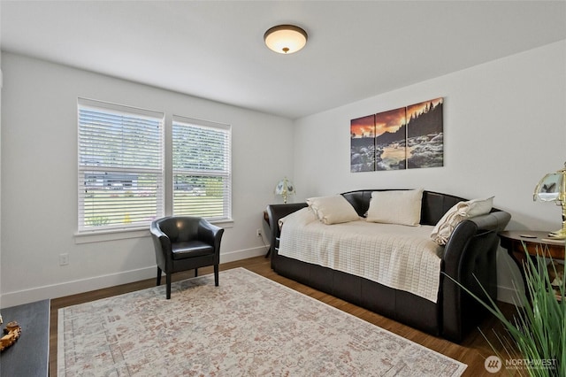 bedroom with wood finished floors and baseboards