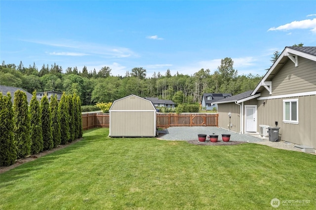 view of yard with a shed, an outdoor structure, central air condition unit, and a patio area