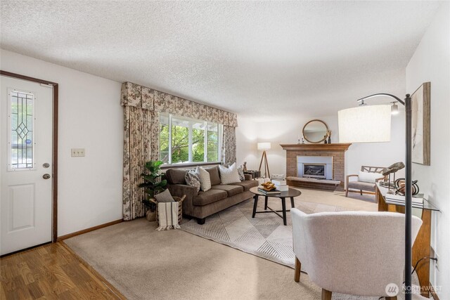 1102 S Villard St, Tacoma, WA 98465 - living room featuring a fireplace, wood finished floors, a textured ceiling, and baseboards