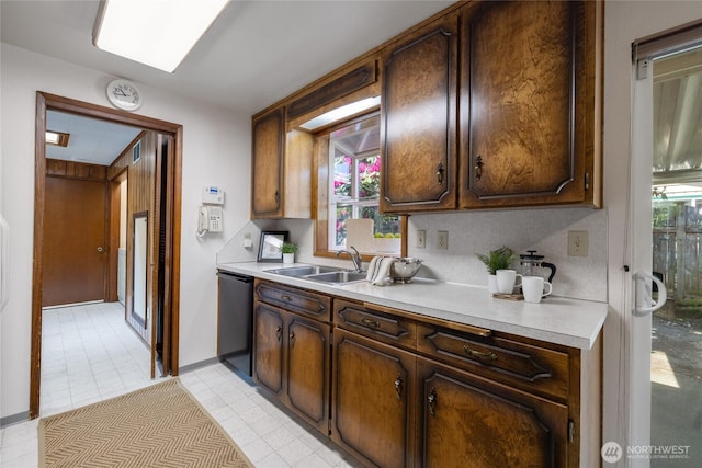 1102 S Villard St, Tacoma, WA 98465 - kitchen featuring a sink, dishwasher, light countertops, dark brown cabinetry, and light tile patterned floors
