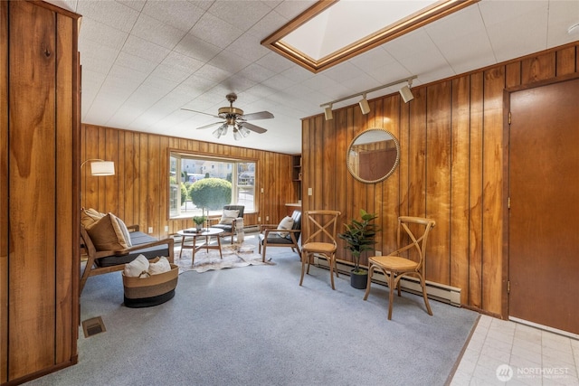 1102 S Villard St, Tacoma, WA 98465 - living area with track lighting, wooden walls, a skylight, ceiling fan, and carpet flooring