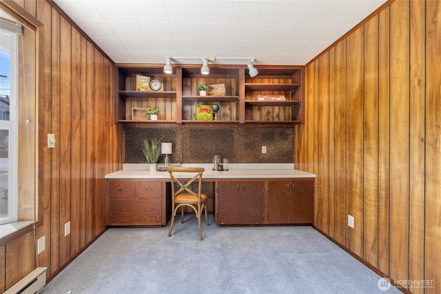 1102 S Villard St, Tacoma, WA 98465 - office area with wooden walls, built in desk, light colored carpet, and a baseboard heating unit