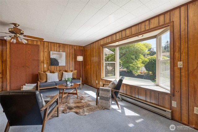 1102 S Villard St, Tacoma, WA 98465 - living room featuring a baseboard heating unit, wood walls, carpet floors, and a ceiling fan