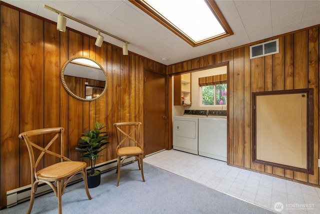 1102 S Villard St, Tacoma, WA 98465 - clothes washing area with rail lighting, separate washer and dryer, wood walls, a baseboard radiator, and light colored carpet