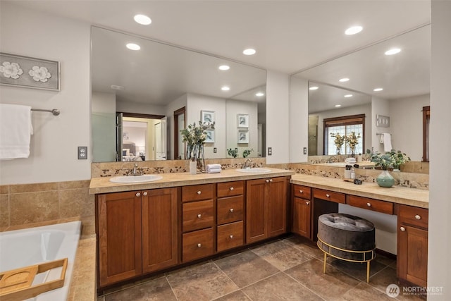 full bathroom with a bath, recessed lighting, and double vanity