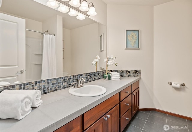 bathroom featuring backsplash, tile patterned floors, vanity, baseboards, and a shower with shower curtain