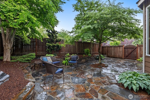 view of patio / terrace featuring a fenced backyard and a gate