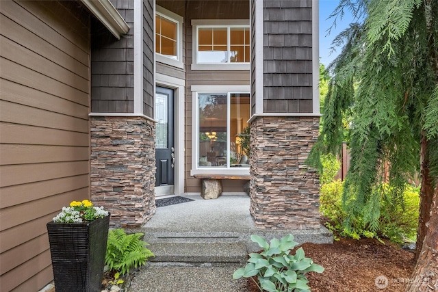 property entrance featuring stone siding