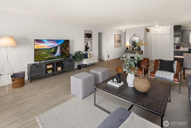 living area with wood finished floors and baseboards