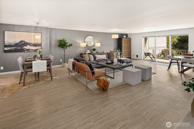 living area with light wood-style floors and baseboards