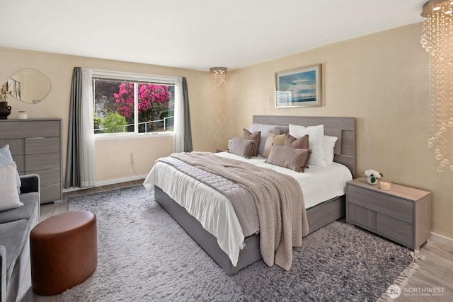 bedroom featuring wood finished floors and baseboards