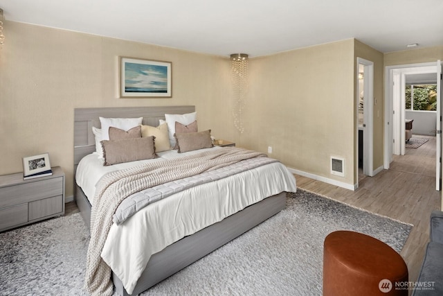bedroom featuring wood finished floors and baseboards