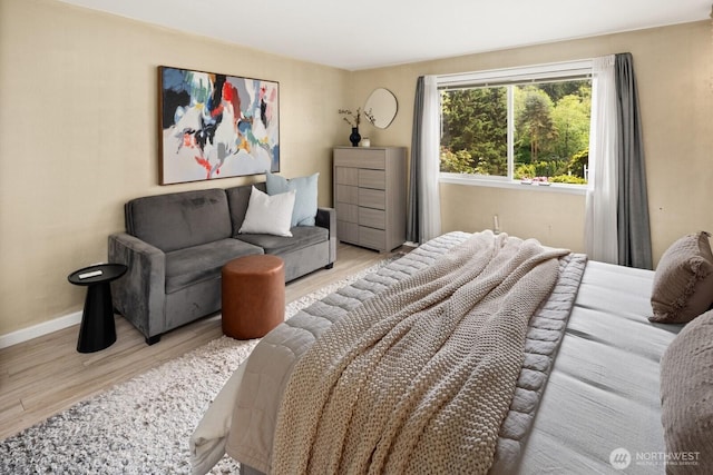 bedroom with wood finished floors and baseboards