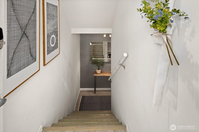 stairs with wood finished floors