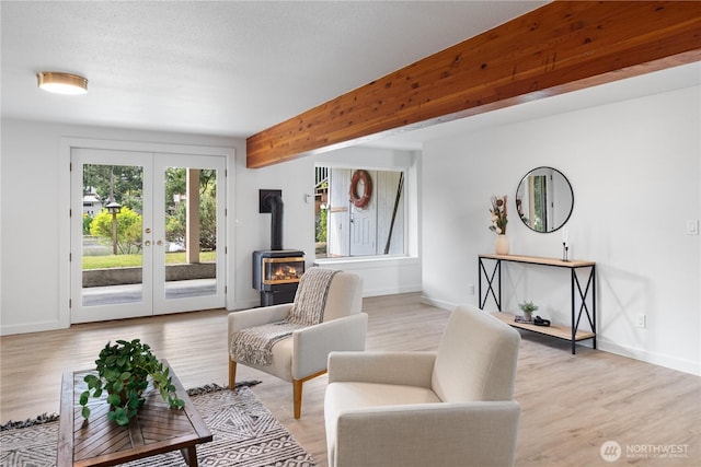 2419 Rocky Point Rd NW, Bremerton, WA 98312 - sitting room featuring a wood stove, french doors, and light wood-style floors