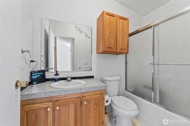 5211 S Aspen, Spokane, WA 99224 - full bathroom with toilet, vanity, and shower / bath combination with glass door