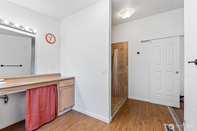 5211 S Aspen, Spokane, WA 99224 - full bath featuring a tile shower, wood finished floors, vanity, and baseboards