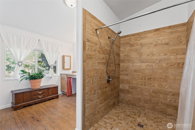 5211 S Aspen, Spokane, WA 99224 - bathroom with tiled shower, wood finished floors, vaulted ceiling, and vanity