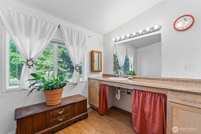 5211 S Aspen, Spokane, WA 99224 - bathroom with wood finished floors, vaulted ceiling, and vanity
