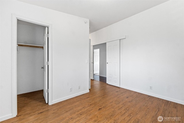 5211 S Aspen, Spokane, WA 99224 - unfurnished bedroom with wood finished floors, a walk in closet, and baseboards
