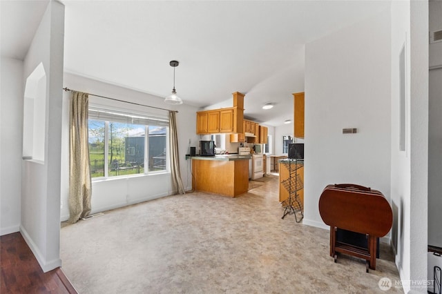 5211 S Aspen, Spokane, WA 99224 - kitchen with lofted ceiling, baseboards, white electric stove, decorative light fixtures, and a peninsula