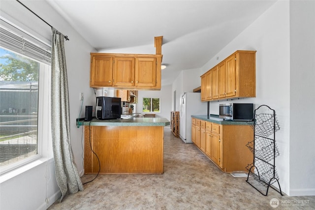 5211 S Aspen, Spokane, WA 99224 - kitchen with stainless steel microwave, freestanding refrigerator, healthy amount of natural light, a peninsula, and lofted ceiling