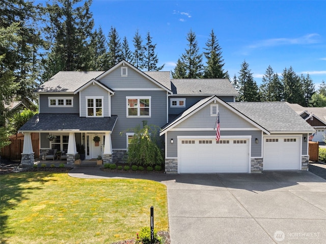 191 E Sterling Dr, Allyn, WA 98524 - craftsman inspired home with stone siding, covered porch, driveway, a front lawn, and an attached garage