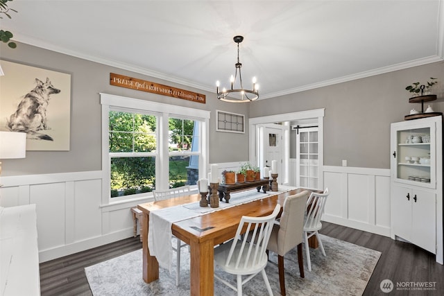 191 E Sterling Dr, Allyn, WA 98524 - dining space with a chandelier, dark wood-style floors, a decorative wall, ornamental molding, and a wainscoted wall